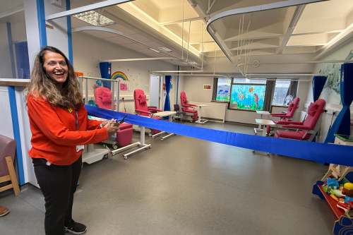 Selina cutting a blue ribbon at the allergy clinic
